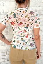 A pink sheer mesh short-sleeved love wild dreamer top with wild dreamer western cacti and cowboy boot prints