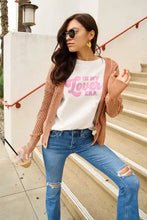 Woman in Lover Era Round Neck White T-Shirt with Ripped Jeans and Cardigan