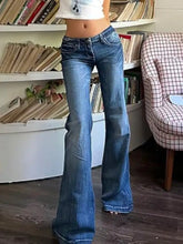 Low rise flare blue denim jeans with a classic slightly worn look and flare silhouette