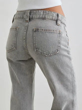 Light gray denim low rise flare leg jeans with a faded wash and classic back pockets shown from the back side