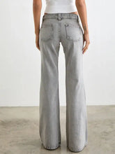 Light gray low rise flare leg jeans in denim with a faded wash and classic back pockets shown from the back side
