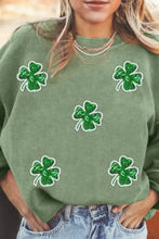 Green corduroy sweater with sequin lucky clover patches and long sleeves