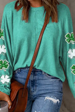 Woman in lucky clover sequin round neck sweatshirt with shamrocks