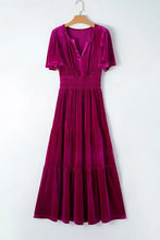 Magenta velvet maxi dress with short sleeves, deep V-neck, and pockets