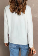 Maple leaf round neck long sleeve white textured top with blue jeans
