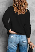 Mardi Gras sequin round neck sweatshirt with black jeans and bracelet