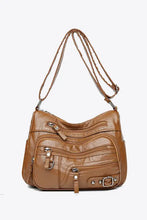 Maroon faux leather crossbody bag with adjustable strap and zippered pockets