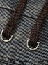 Mens camouflage cargo drawstring pants with brown drawstrings and silver D-rings on blue denim