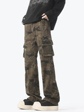 Men’s camouflage cargo jeans in olive and dark green with multiple pockets and durable fabric for outdoor use
