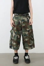 Man in loose-fitting mens camouflage denim cargo cropped pants