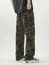 Men’s camouflage loose fit jeans in olive and dark green denim with multiple pockets and durable fabric