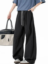 Mens casual wide leg drawstring pants in black with white drawstring