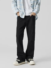 Men’s classic straight fit jeans in black chinos with a clean tailored fit showcasing straight fit design