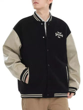 Men’s contrast snap down jacket in black and beige with leather sleeves and white embroidered text on chest