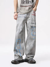 Men’s gray wide-leg jeans with distressed graffiti print featuring blue and red doodles for casual wear
