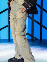 Men’s light-wash denim loose fit jeans with distressed ripped patches and multiple utility cargo pockets