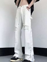Men’s white distressed raw hem wide leg jeans with ripped knees and side zipper detail in denim material