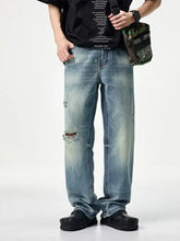 Men’s light-wash denim distressed relaxed fit jeans with ripped knees for casual wear