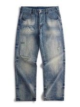 Men’s blue denim distressed relaxed fit jeans with faded look and subtle wave-like patterns