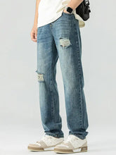 Men’s blue distressed denim relaxed fit jeans with ripped knee patches showcasing a casual fit jeans style