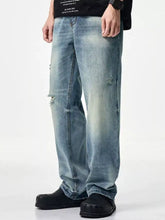 Men’s light-wash denim distressed relaxed fit jeans with ripped details and a straight-leg cut