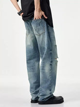 Men’s distressed relaxed fit jeans in light-wash denim with ripped knees and a wide-leg cut