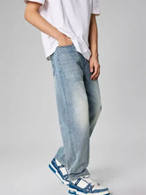 Men’s distressed relaxed fit light-wash denim jeans with a straight-leg cut and subtle fading