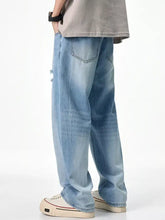 Men’s light-wash denim relaxed fit jeans with a wide-leg cut and subtle thigh distressing for casual wear