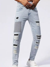 Men’s distressed slim fit light-wash denim jeans with ripped patches black stripes and textured patchwork design