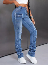 Men’s distressed slim fit jeans in blue denim with ripped patches and a high-rise tapered fit