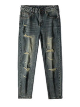 Men’s distressed slim fit dark-wash denim jeans with intentional rips and faded patches along the thighs