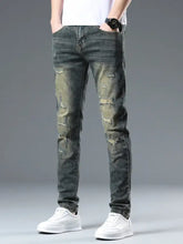 Men’s distressed slim fit dark-wash denim jeans with ripped details along the thighs and knees