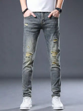 Men’s distressed slim fit gray denim jeans with intentional rips and faded patches for a casual look