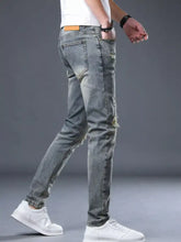 Men’s distressed slim fit gray denim jeans with ripped knees and faded wash made from durable cotton material
