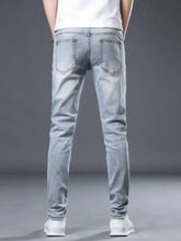 Light-wash denim jeans with a slim fit and subtle distressing on the back pockets.