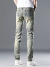 Men’s distressed slim fit jeans in light-wash denim with a slim cut and subtle fading on the thighs