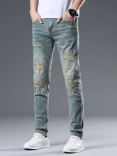 Men’s distressed slim fit light-wash denim jeans with multiple ripped patches and faded detailing