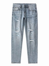 Men’s distressed slim fit light-wash denim jeans with ripped details and white paint splatter accents