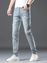 Men’s slim fit light-wash denim jeans with distressed ripped details on thighs and knees for casual wear