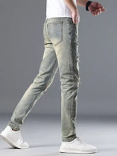 Men’s distressed slim fit light-wash denim jeans with ripped details along the thighs and knees