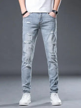 Men’s light-wash slim fit denim jeans with distressed ripped details on thighs and knees for a stylish fit look