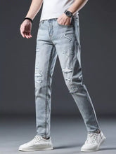 Men’s distressed slim fit light-wash denim jeans featuring ripped details and subtle fading for casual wear