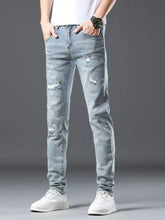 Men’s distressed slim fit light-wash denim jeans with ripped details showcasing a casual and modern style