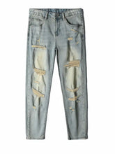 Men’s light-wash slim fit jeans with distressed ripped patches on thighs and knees in slim fit denim design