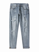 Men’s slim fit jeans in light-wash denim with distressed ripped details and rolled cuffs for a stylish look