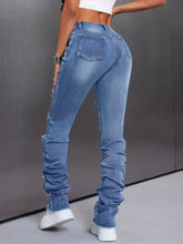 Men’s distressed slim fit light-wash denim jeans with ruched detailing and frayed hems for a stylish casual look