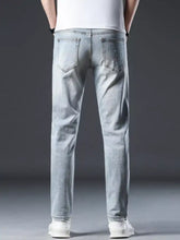 Men’s distressed slim fit light-wash denim jeans with subtle white speckle detailing for casual wear