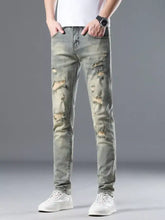 Men’s distressed slim fit olive green denim jeans featuring intentional rips and frayed edges for a stylish look