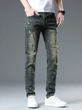 Men’s distressed slim fit dark-wash denim jeans with intentional rips and faded patches along the legs