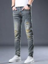 Men’s distressed slim fit jeans in gray denim with ripped knees and faded wash for casual wear